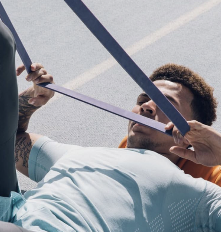 An athlete exercising with a resistance band